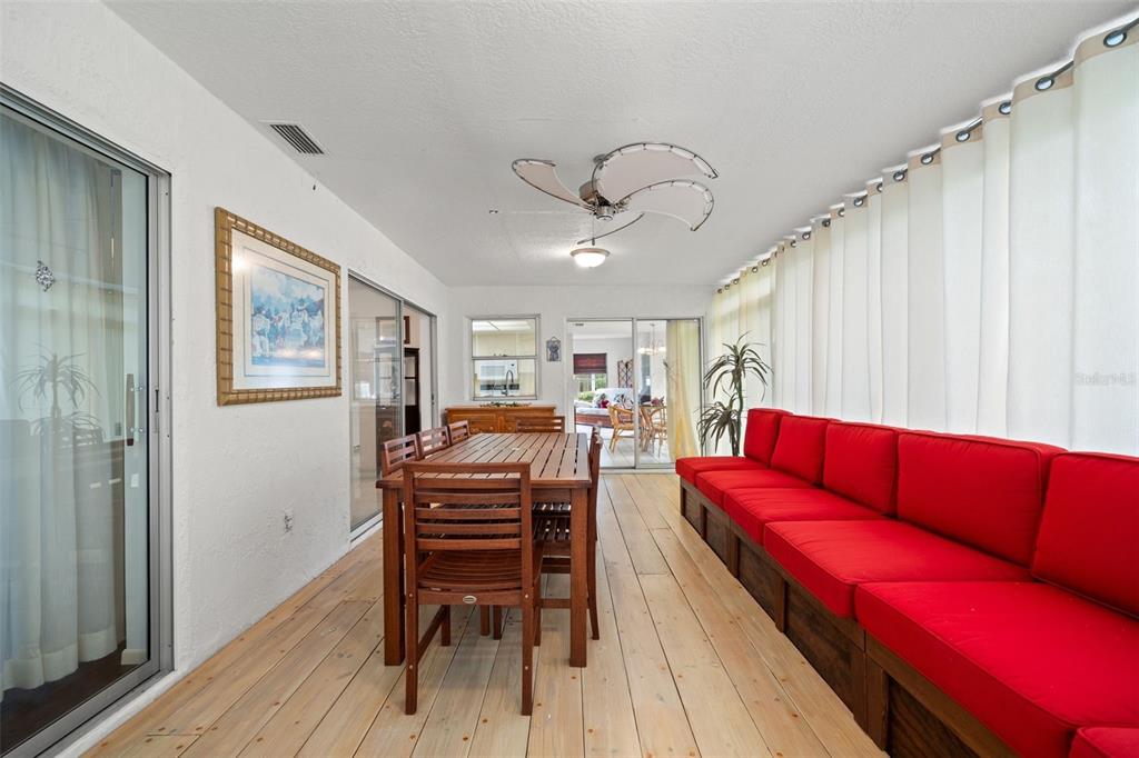 6404 Lost Tree Lane Spring Hill, FL 34606 - Photo 20 of 63 a living room with furniture a flat screen tv and a wooden floor