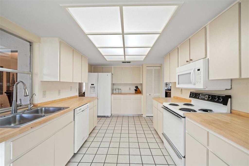 6404 Lost Tree Lane Spring Hill, FL 34606 - Photo 27 of 63 a kitchen with a sink a stove cabinets and counter space
