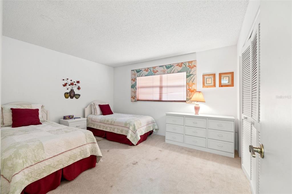 6404 Lost Tree Lane Spring Hill, FL 34606 - Photo 34 of 63 a bedroom with two beds and a window