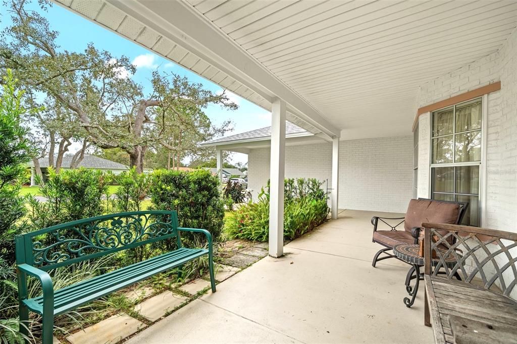 6404 Lost Tree Lane Spring Hill, FL 34606 - Photo 6 of 63 a view of a patio with table and chairs and potted plants