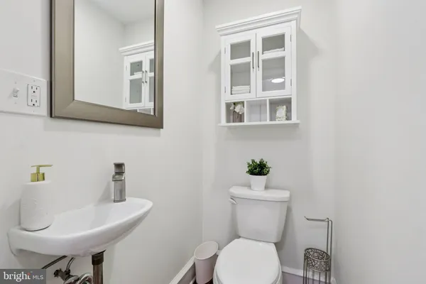 a view of a dining room with furniture a chandelier and wooden floor