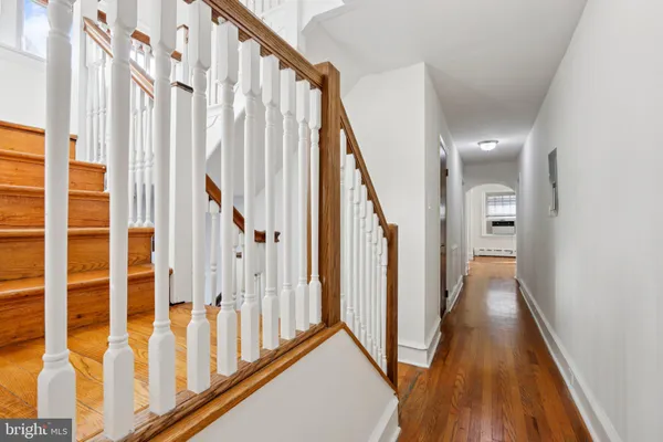 a kitchen with stainless steel appliances granite countertop a stove top oven a sink dishwasher a dining table and chairs with wooden floor