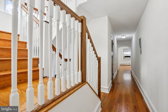 a kitchen with stainless steel appliances granite countertop a stove top oven a sink dishwasher a dining table and chairs with wooden floor