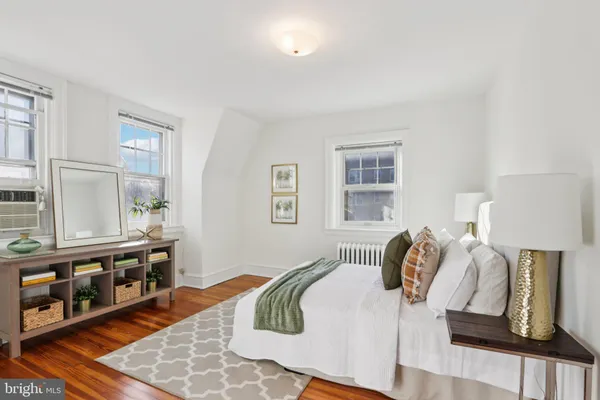 a spacious bedroom with a bed and a couch