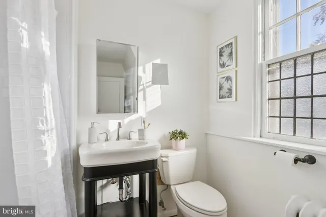 a bathroom with a toilet and a window