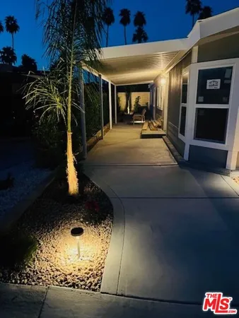 a front view of a house with swimming pool and outdoor seating