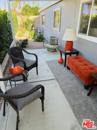 a backyard of a house with table and chairs