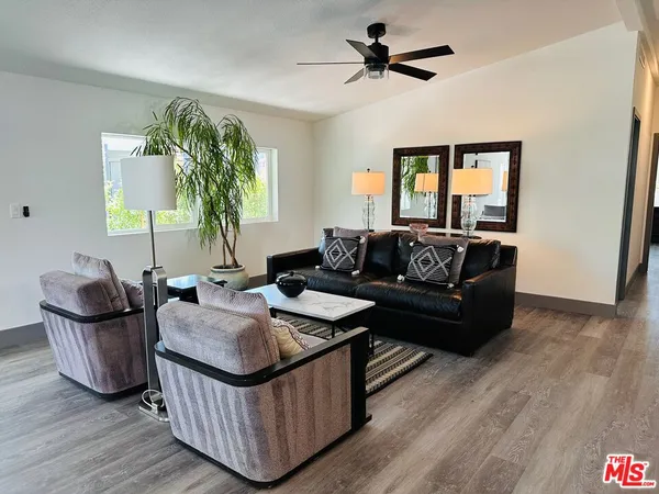 a living room with furniture and a potted plant