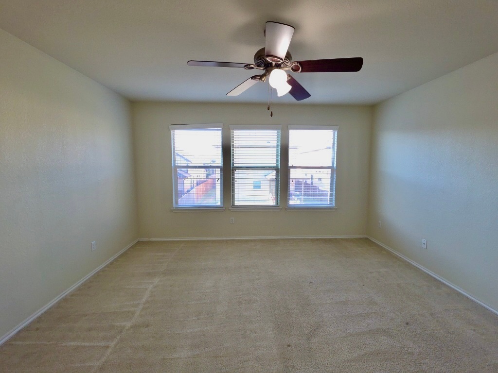 3805 Tranquil Lane Austin, TX 78728 - Photo 14 of 30 an empty room with windows and ceiling fan