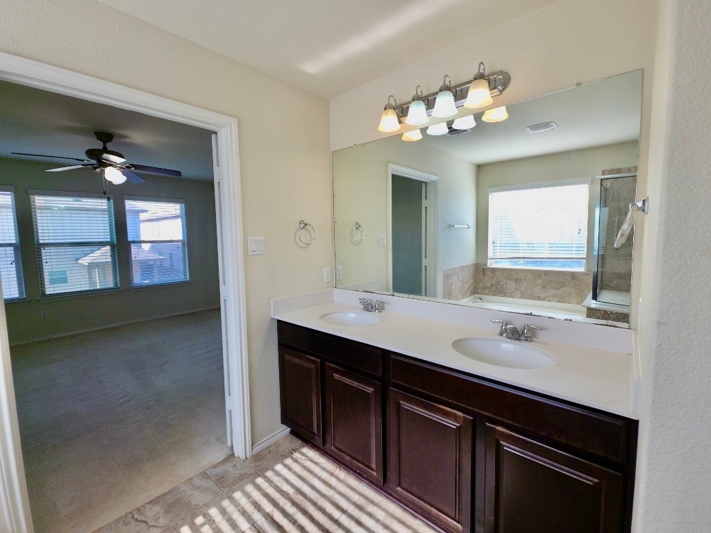 3805 Tranquil Lane Austin, TX 78728 - Photo 16 of 30 a bathroom with a sink vanity and a mirror
