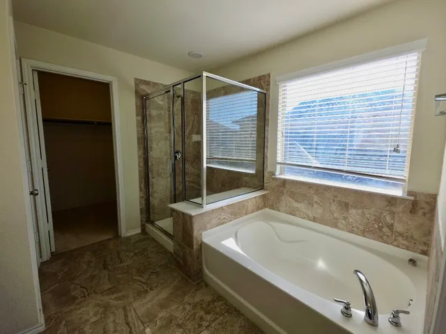 a bathroom with a bathtub and a shower