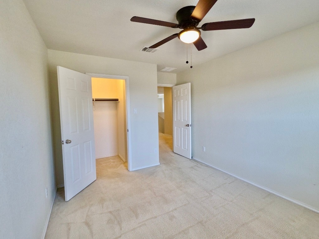 3805 Tranquil Lane Austin, TX 78728 - Photo 24 of 30 an empty room with closet and a chandelier fan