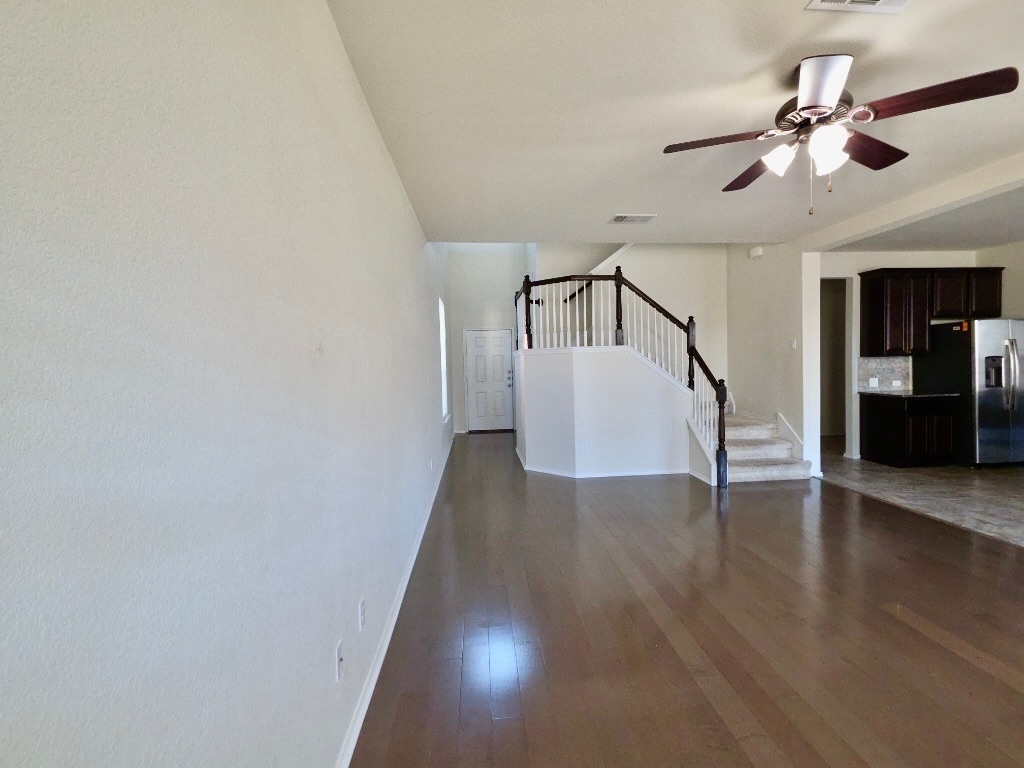 3805 Tranquil Lane Austin, TX 78728 - Photo 5 of 30 a view of a hallway with wooden floor and staircase