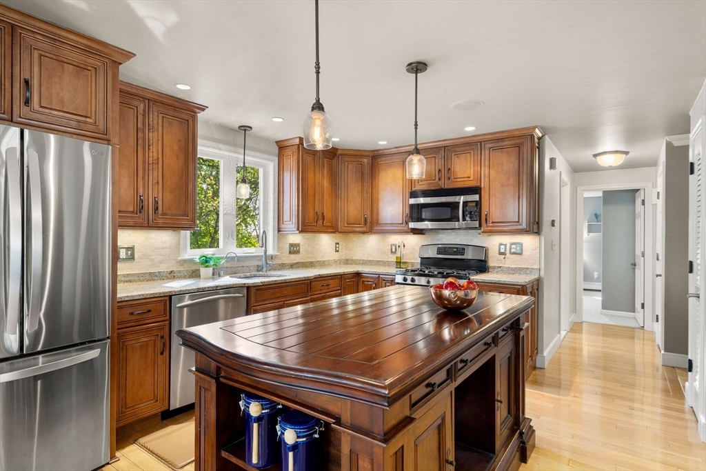 22 Crest Road Framingham, MA 01702 - Photo 11 of 38 a kitchen with a refrigerator a sink a stove and chairs
