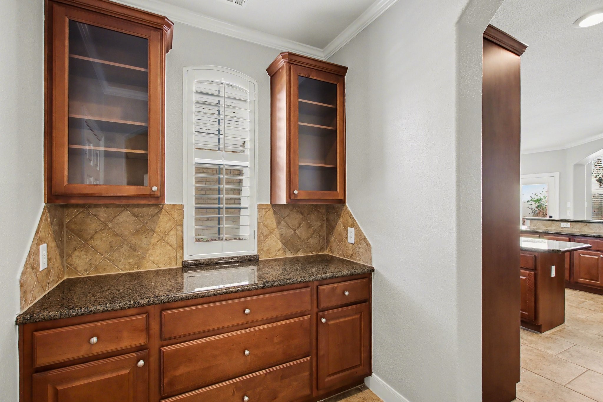 5115 Luke Ridge Lane Katy, TX 77494 - Photo 11 of 36 a kitchen with granite countertop cabinets and window