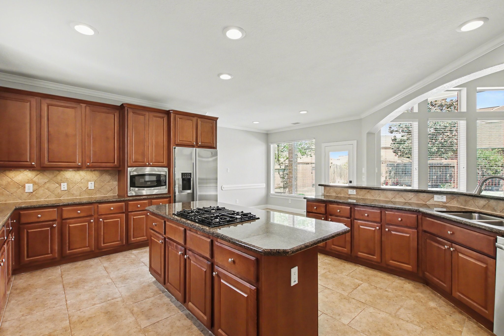 5115 Luke Ridge Lane Katy, TX 77494 - Photo 12 of 36 a kitchen with stainless steel appliances granite countertop a stove a sink dishwasher a refrigerator and a stove with wooden cabinets