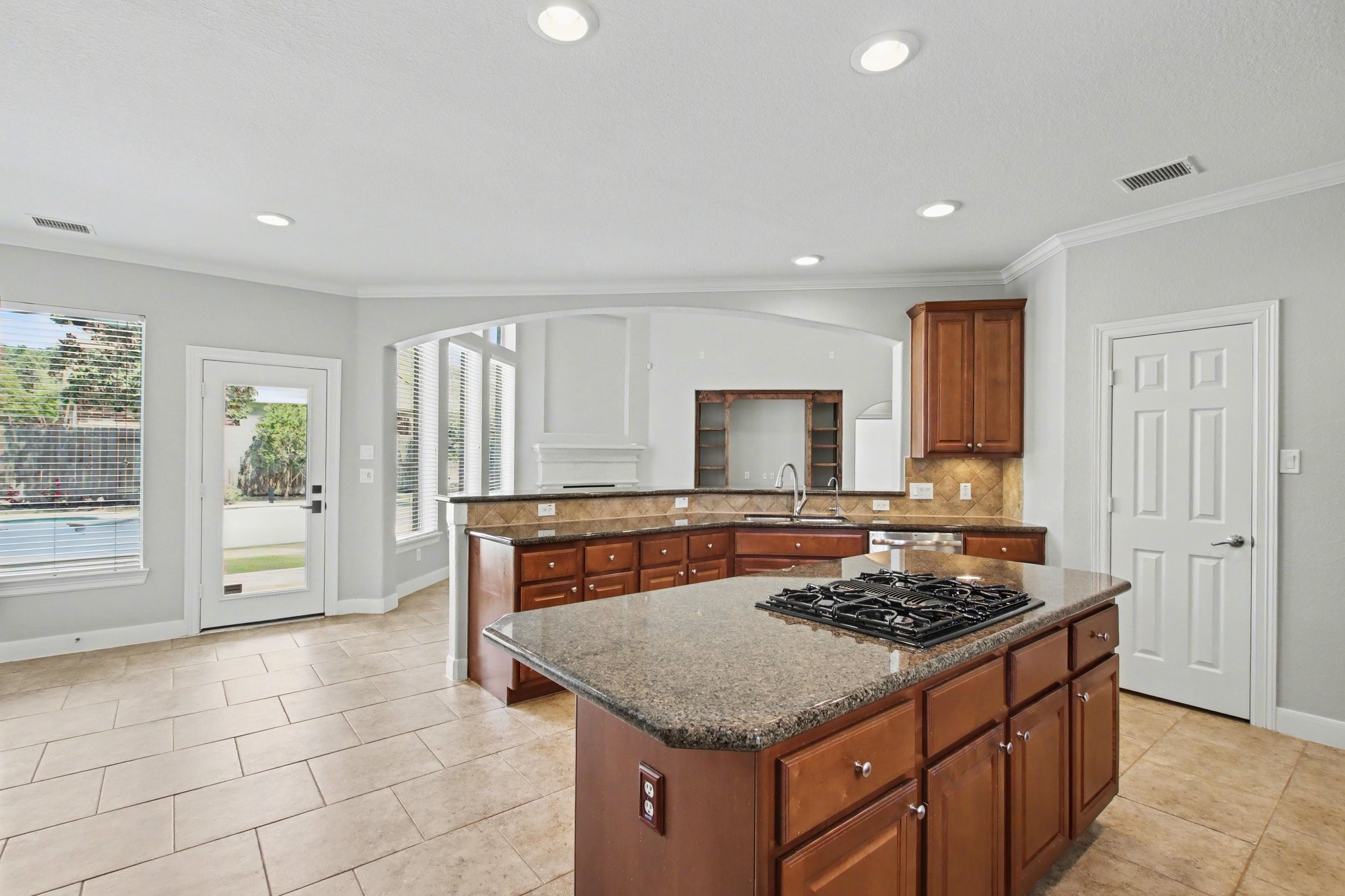 5115 Luke Ridge Lane Katy, TX 77494 - Photo 13 of 36 a kitchen with a stove a sink a refrigerator and wooden cabinets