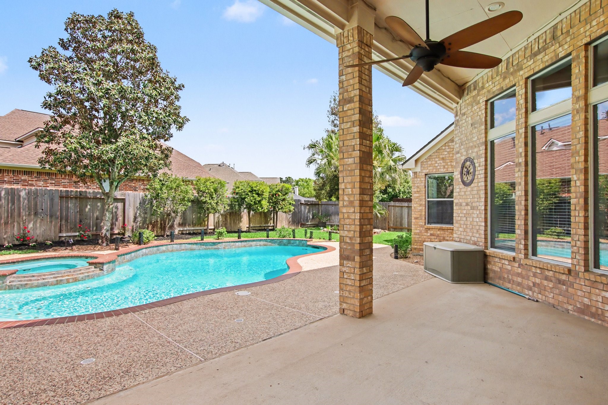 5115 Luke Ridge Lane Katy, TX 77494 - Photo 34 of 36 a view of a house with a big yard and palm trees