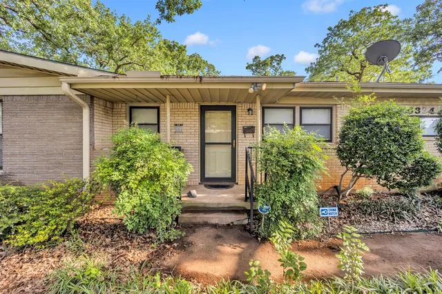 front view of a house with potted plants