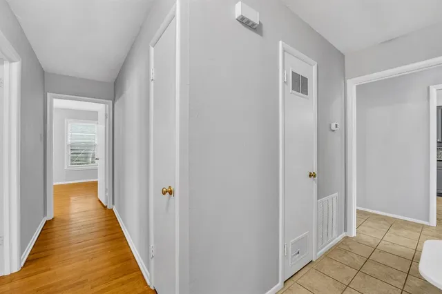 a view of a hallway with wooden floor and entryway