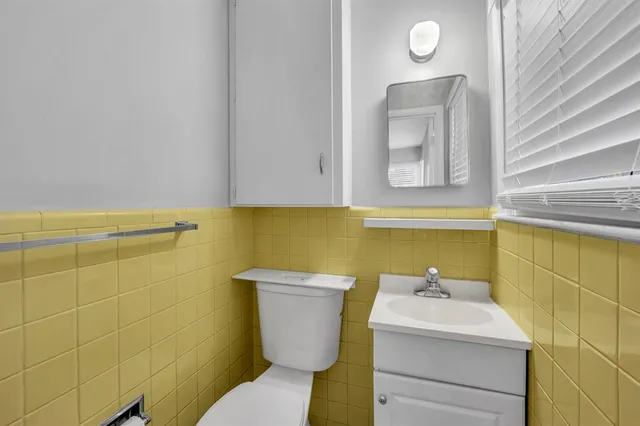 a bathroom with a sink mirror and toilet