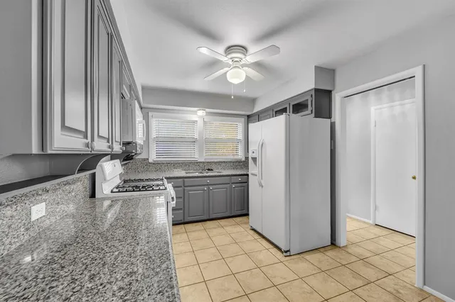 a kitchen with stainless steel appliances granite countertop a refrigerator a sink and dishwasher