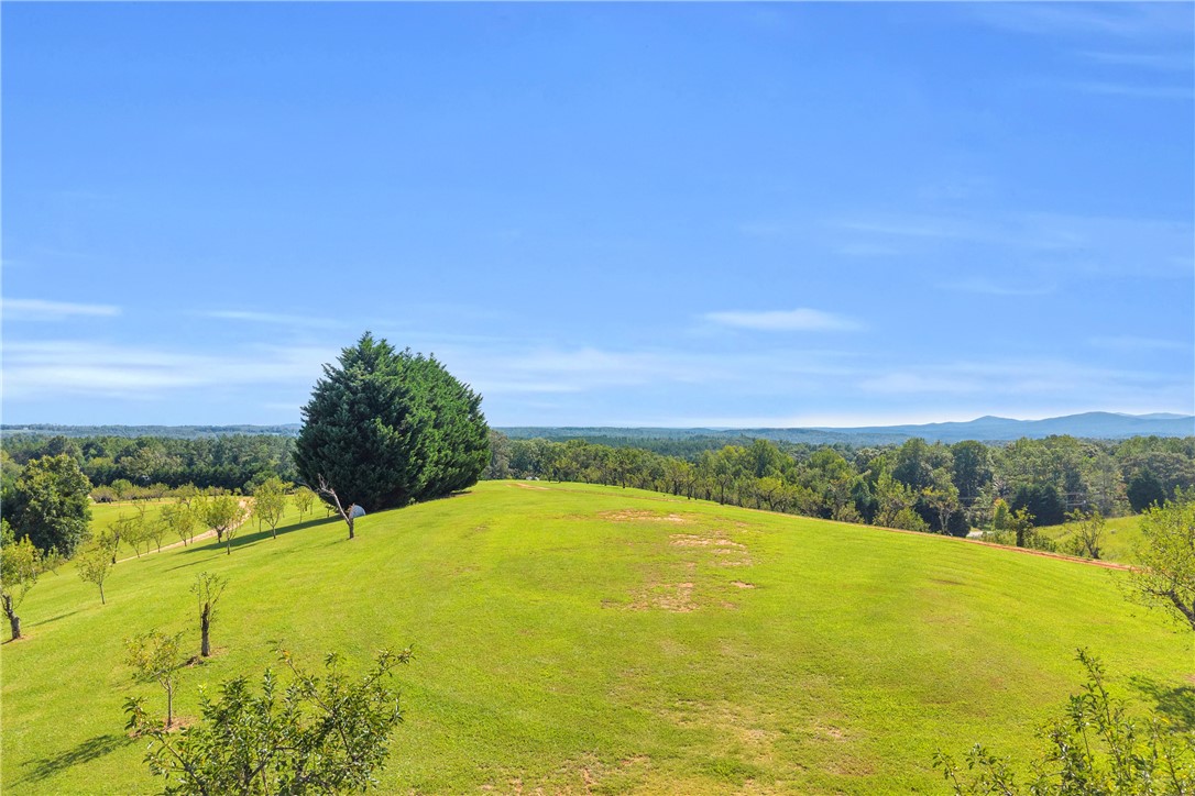 498 Raines Road Mountain Rest, SC 29664 - Photo 14 of 48 Rolling green hills and distant mountain peaks create a picturesque backdrop for this expansive property.