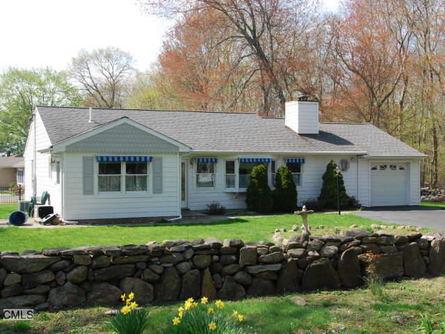 173 West Rocks Road Norwalk, CT 06851 - Photo 1 of 1 a front view of a house with a garden