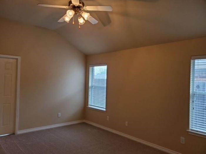 3137 Evangeline Road Fort Worth, TX 76140 - Photo 10 of 13 an empty room with windows and chandelier fan