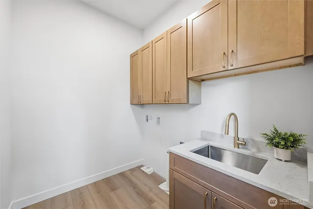 a view of kitchen with a sink and cabinets