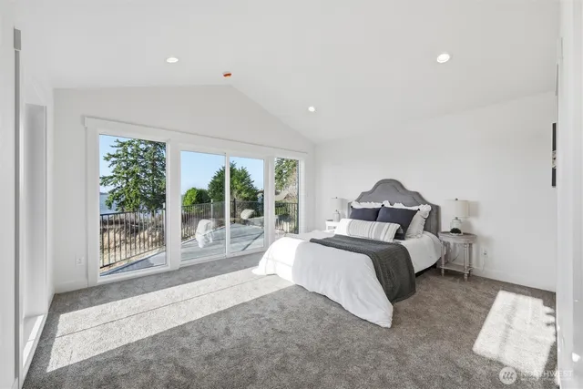 a spacious bedroom with a bed and a large window