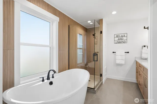 a bathroom with a tub sink and mirror