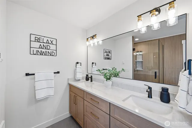 a bathroom with a granite countertop sink mirror and vanity