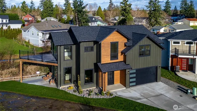 a aerial view of a house with a yard and potted plants