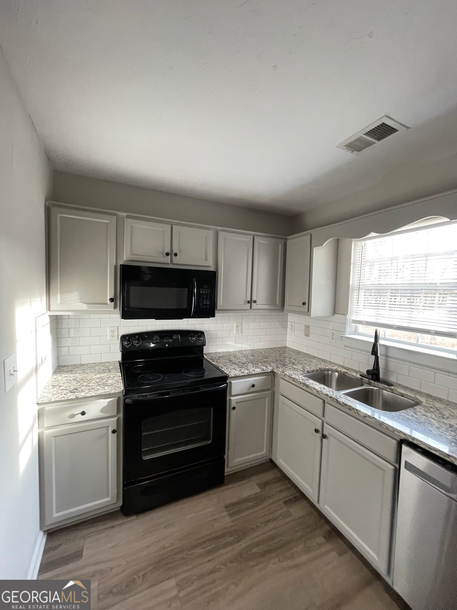 42 Pope Road Villa Rica, GA 30180 - Photo 5 of 14 a kitchen with a sink stove and microwave