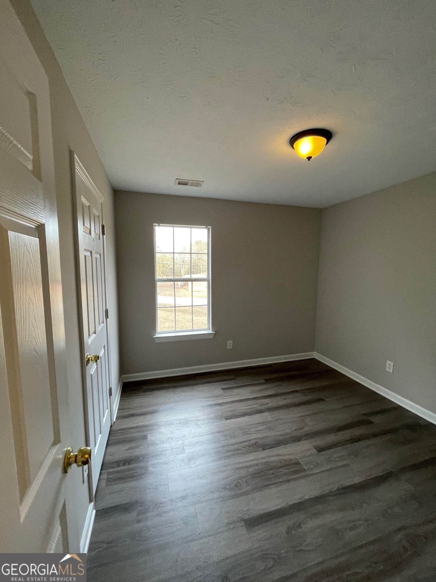 42 Pope Road Villa Rica, GA 30180 - Photo 8 of 14 a view of an empty room with a window and wooden floor