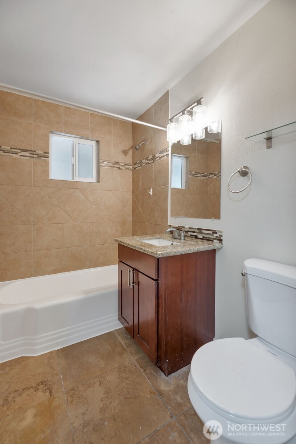 11229 29th Avenue Southwest Seattle, WA 98146 - Photo 15 of 28 a bathroom with a granite countertop toilet sink and mirror