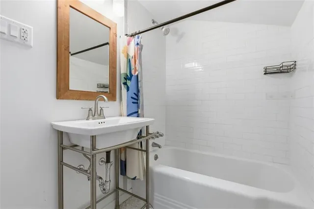 a bathroom with a bath tub and shower