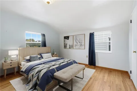 a bedroom with a bed and a painting on the wall