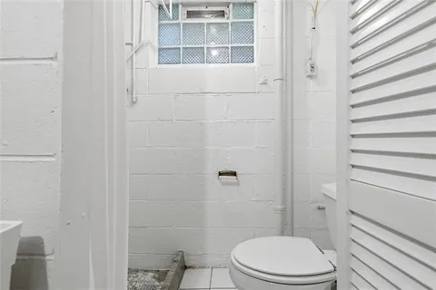a white toilet sitting next to a bathroom sink