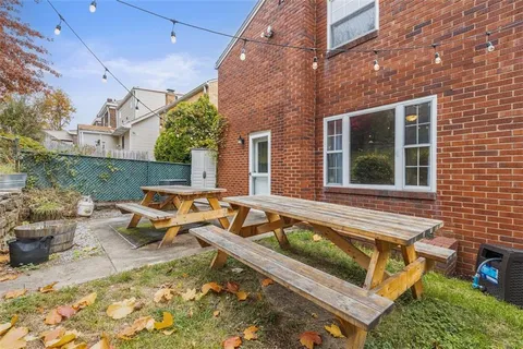 a view of a house with pool and chairs