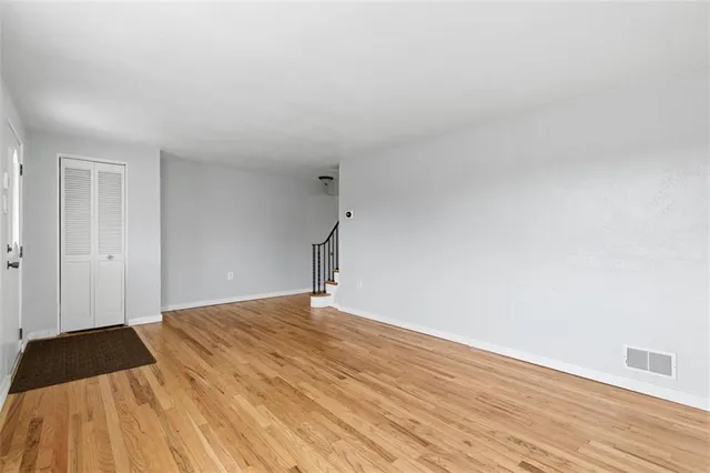 a view of an empty room and wooden floor