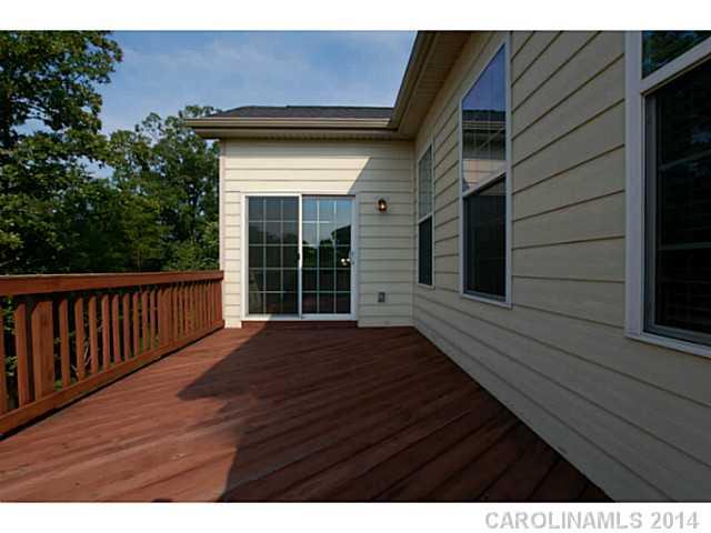 339 Calming Way Tega Cay, SC 29708 - Photo 3 of 16 a view of backyard with wooden deck and floor to ceiling window