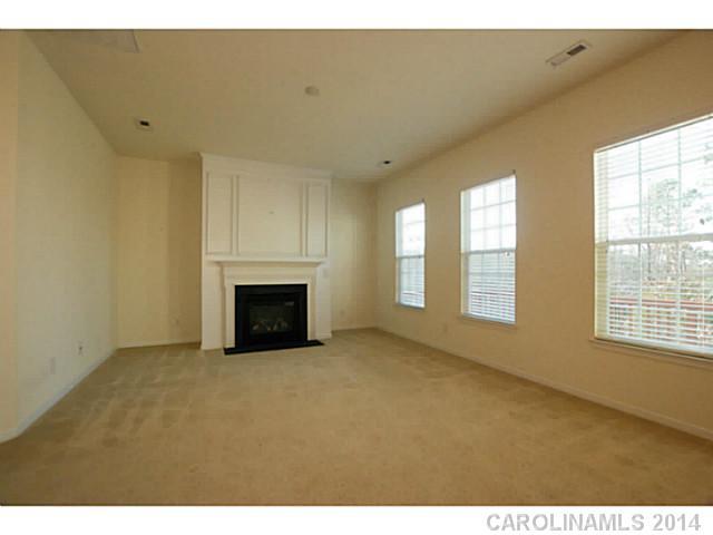 339 Calming Way Tega Cay, SC 29708 - Photo 9 of 16 a view of empty room with a fireplace