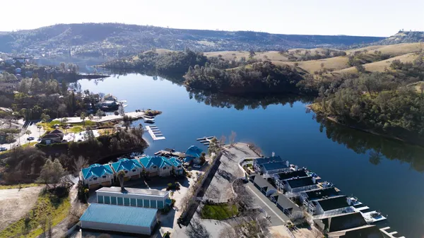 an aerial view of a house with a lake view