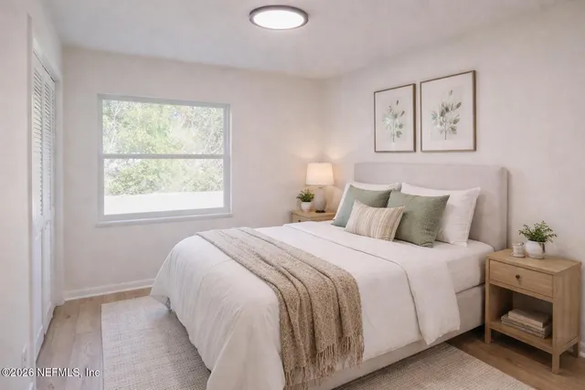 a bedroom with a bed and a window