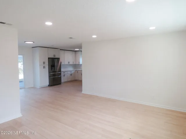 a view of a kitchen with a sink and stainless steel appliances