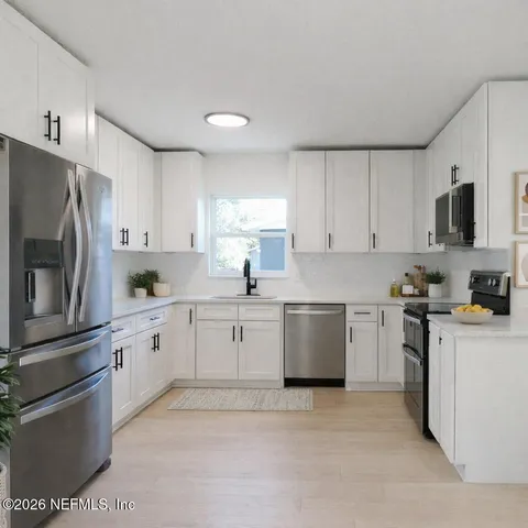 a kitchen with cabinets stainless steel appliances and a counter space