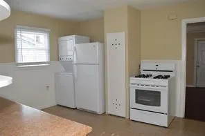 a kitchen with a stove and a refrigerator