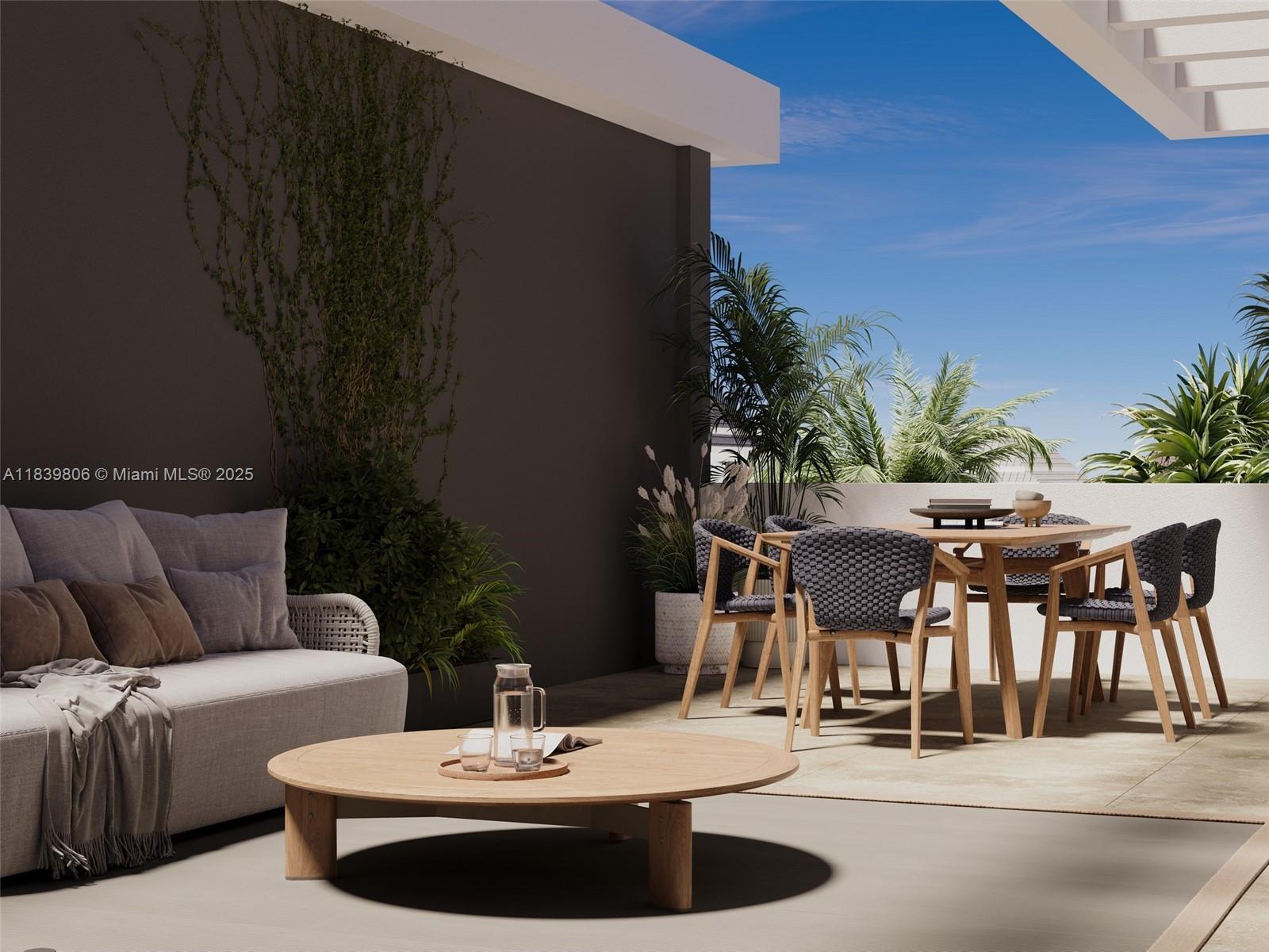 1709 Jefferson Avenue, Unit TH03 Miami Beach, FL 33139 - Photo 15 of 16 a view of a patio with table and chairs potted plants with wooden floor